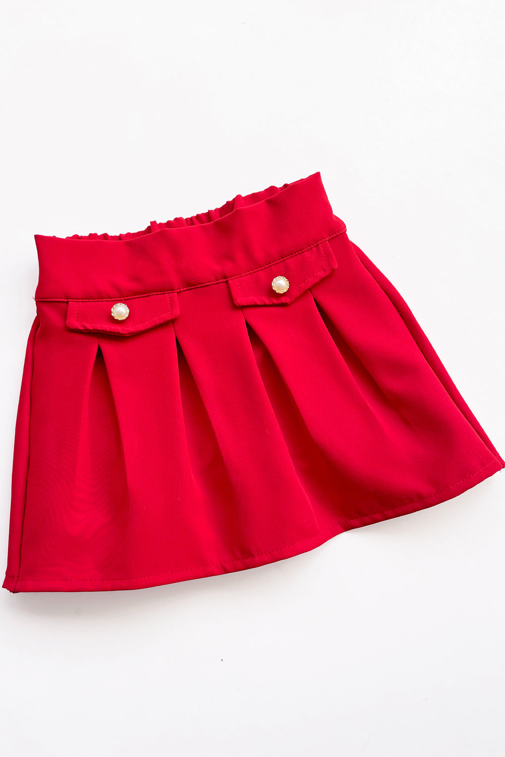 Falda tableada con elasticado en pretina